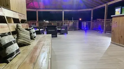 a large room with a wooden bench and chairs in it at Hacienda Francisco in Concepción de La Vega