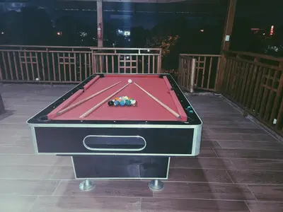 a pool table sitting on top of a deck at Hacienda Francisco in Concepción de La Vega