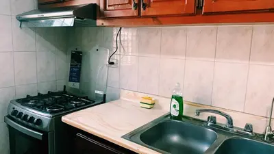 a kitchen with a sink and a stove at Hacienda Francisco in Concepción de La Vega