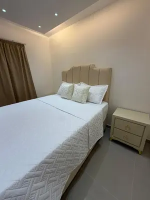 a bed with white sheets and pillows in a bedroom at Piscina Playa 3 Min Aeropuerto Cerca in Boca Chica