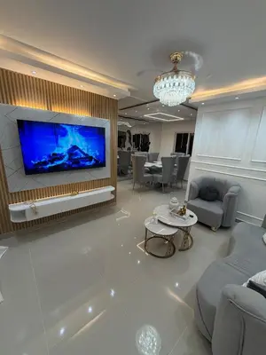 a living room with a large flat screen tv at Piscina Playa 3 Min Aeropuerto Cerca in Boca Chica