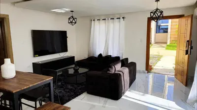 a living room with a couch and a tv at Villa Brisa Marina in Boca Chica