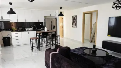 a kitchen and living room with a couch and a table at Villa Brisa Marina in Boca Chica