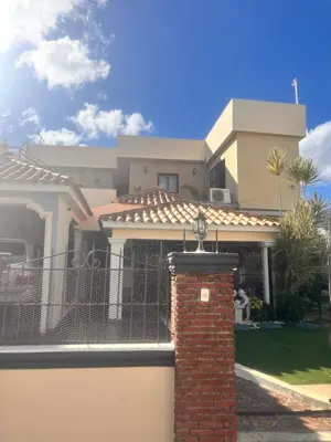 a house with a gate and a brick pillar at El descanso in Higuey