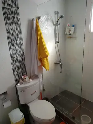 a bathroom with a toilet and a glass shower at My house 56 in San Francisco de Macorís