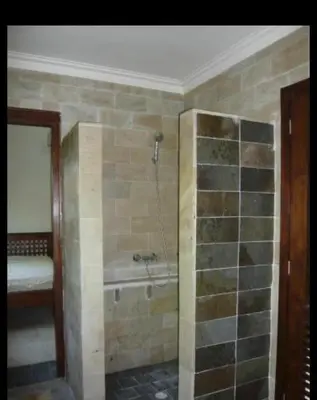 a bathroom with a bath tub in a room at Villa exotic in Juan Dolio