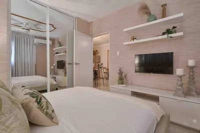 a bedroom with a bed and a television on a wall at ®{The-Comfty-Spot} Experience @SD WiFi in Santo Domingo