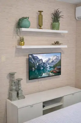 a living room with a tv on a wall at ®{The-Comfty-Spot} Experience @SD WiFi in Santo Domingo