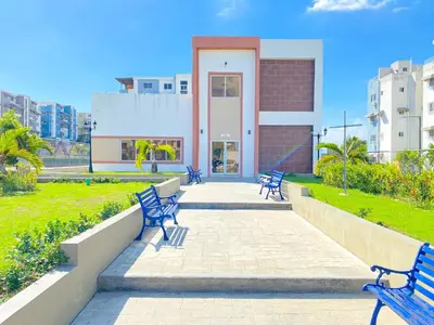 a group of blue benches in front of a building at ®{The-Comfty-Spot} Experience @SD WiFi in Santo Domingo