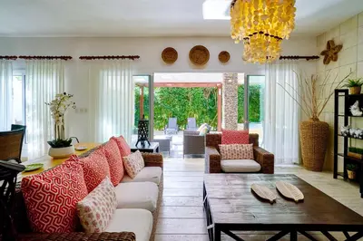 a living room with a couch and a table at ®2BR{Beach~Spot} @TerrenasJaccuziWalk~to~Beach in El Limón