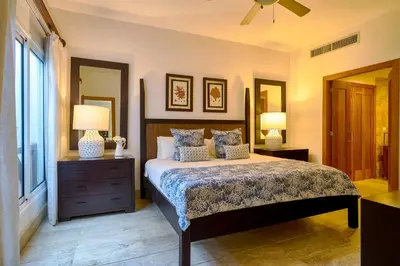 a bedroom with a bed and two lamps and a window at ®2BR{Beach~Spot} @TerrenasJaccuziWalk~to~Beach in El Limón