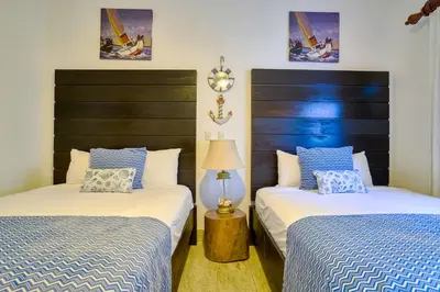a bedroom with two beds and a lamp at ®2BR{Beach~Spot} @TerrenasJaccuziWalk~to~Beach in El Limón