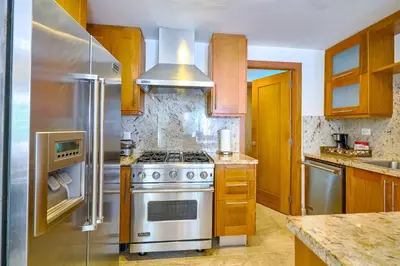 a kitchen with a stove and a stainless steel refrigerator at ®2BR{Beach~Spot} @TerrenasJaccuziWalk~to~Beach in El Limón