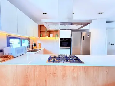 a kitchen with a white counter top and a refrigerator at Gardenia Beachside Living in Punta Cana