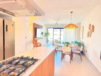 a kitchen and dining room with a stove top at Gardenia Beachside Living in Punta Cana