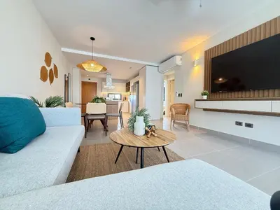 a living room with a couch and a table at Gardenia Beachside Living in Punta Cana