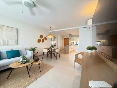 a living room with a couch and a table at Gardenia Beachside Living in Punta Cana