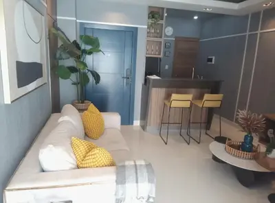 a living room with a couch and a kitchen at Sky 01 M11 in Santo Domingo
