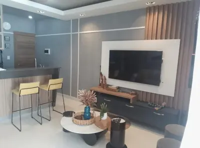 a living room with a tv and a table and chairs at Sky 01 M11 in Santo Domingo