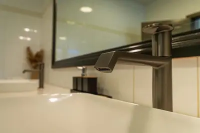a bathroom sink with a faucet and a mirror at Oris Chic & Tropical Suite, Breakfast in Las Terrenas