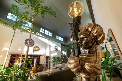 a statue of a girl in a room with plants at Oris Chic & Tropical Suite, Breakfast in Las Terrenas
