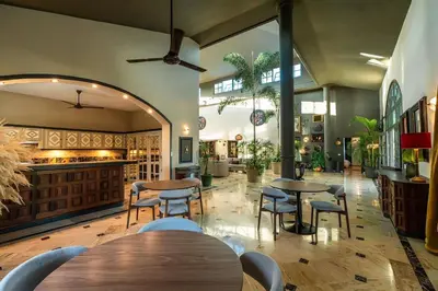 a restaurant with tables and chairs in a room at Oris Chic & Tropical Suite, Breakfast in Las Terrenas