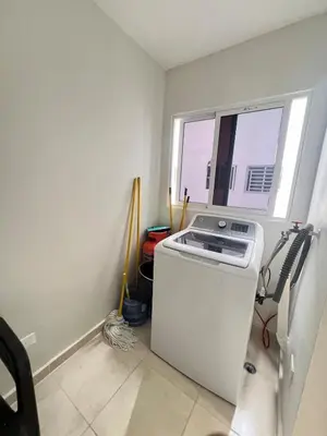 a washing machine in a room with a window at Apartamento en bani in Baní