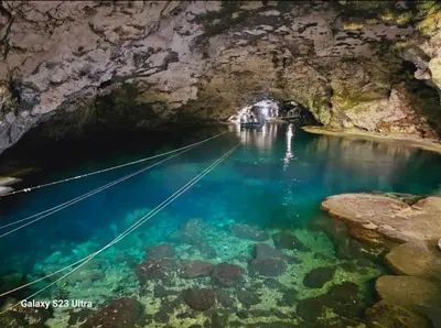 a boat in the water in a cave at Civil tower oceance in Santo Domingo