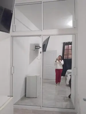 a woman standing in front of a mirror in a room at Brisa del mar in Boca Chica