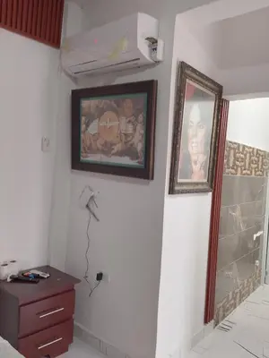 a room with two pictures on the wall and a dresser at Brisa del mar in Boca Chica