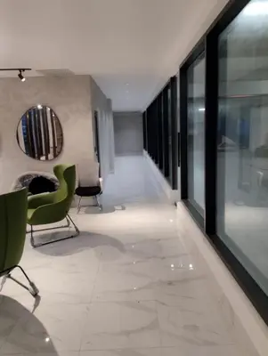a living room with green chairs and a mirror at Comfortable oceanfront apartment on Av España in La Francia