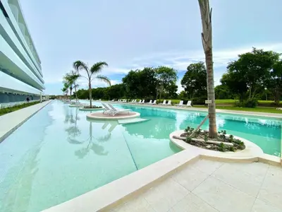 a swimming pool with a palm tree in a building at 1B Fantasy Lodge @t Canabay Private Pool and beach in Punta Cana