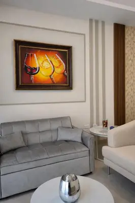 a living room with a couch and a painting of fruit at Modern Luxury Apt Pool, Gym and Prime Location in La Julia