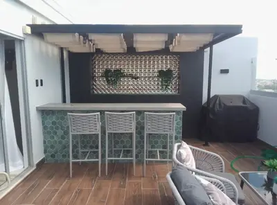 a bar on the back of a house with two chairs at Sky 01 M10 in Santo Domingo