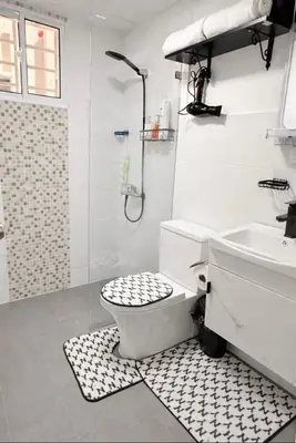 a white bathroom with a toilet and a sink at Comfy & Secure Modern 2BR Apartment just 5 minutes from Airport in Boca Chica in Boca Chica