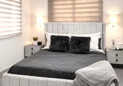 a bedroom with a large bed with two night stands at Comfy & Secure Modern 2BR Apartment just 5 minutes from Airport in Boca Chica in Boca Chica