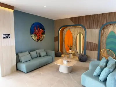 a living room with a couch and a table at Stunning oceanfront apartment in Encuentro at The Wave in Cabarete