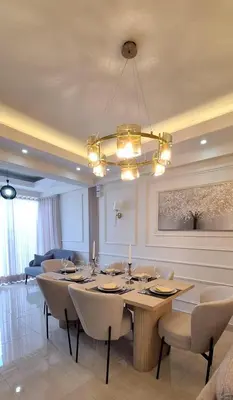 a dining room with a table and chairs and a chandelier at Exclusive apartment in SDE in Juan López