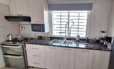 a kitchen with a sink and a counter top at Exclusive apartment in SDE in Juan López