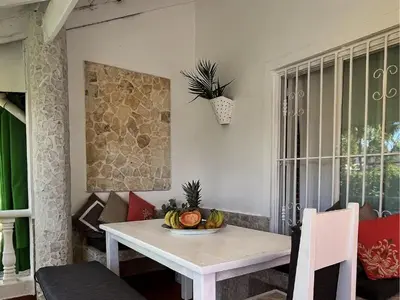 a dining room table with a bowl of fruit on it at Habitat Samaná Apartments - Coral Samanà