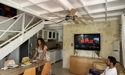 a woman is standing in a living room at Habitat Samaná Apartments - Coral Samanà