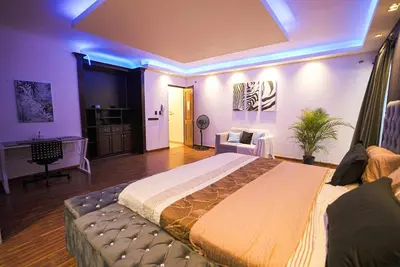 a bedroom with a large bed and a desk at Luxury Caribbean penthouse in Santo Domingo