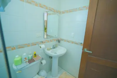 a white bathroom with a sink and a mirror at Luxury Caribbean penthouse in Santo Domingo