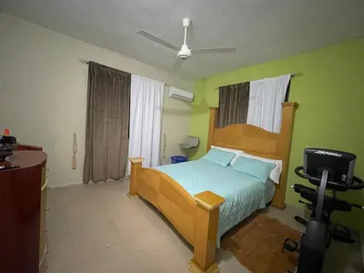 a bedroom with a bed and a television in it at Casa a solo 30 minutos de la playa