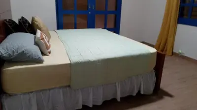 a bed with pillows on it in a room at Alto Nuevo