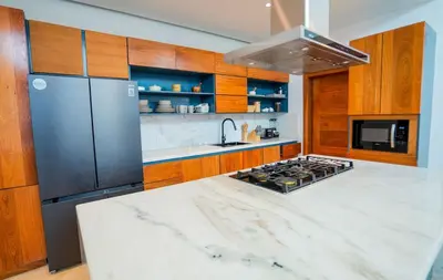 a kitchen with a stainless steel refrigerator and a stove at Modern Villa with a 15m Lap Pool, Cabarete in Cabarete