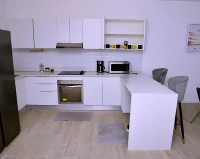 a kitchen with white cabinets and a white counter top at Peaceful 2BR Retreat with Pool, Paddle Court & Private Beach Access in Punta Cana