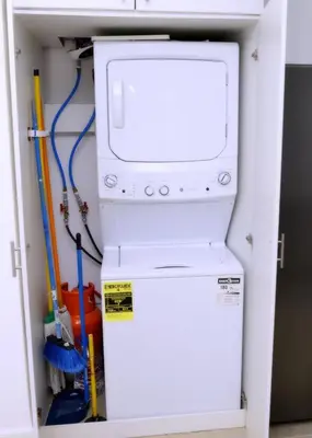 a washer and dryer in a utility room at Peaceful 2BR Retreat with Pool, Paddle Court & Private Beach Access in Punta Cana