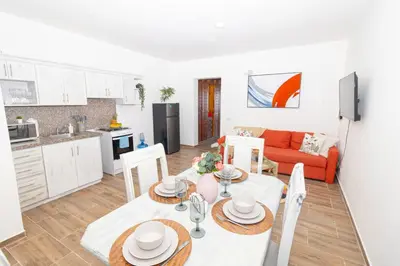 a kitchen and living room with a table and chairs at Caribbean Escape 1BR at Paraiso Bayahibe in Bayahibe