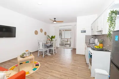 a kitchen and a living room with a table at Caribbean Escape 1BR at Paraiso Bayahibe in Bayahibe